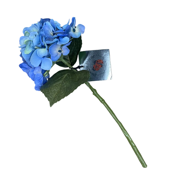 Artificial blue hydrangea flower with a green stem on a beige background