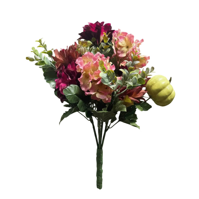 An artificial floral bouquet with pink and burgundy flowers, green leaves, and a small yellow-green pumpkin accent, photographed against a plain light gray background.