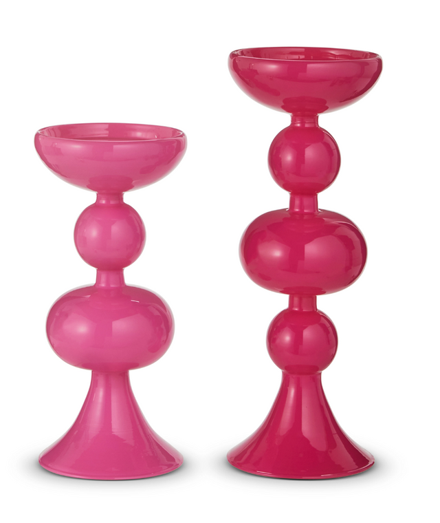 Two pink candle holders on a white background