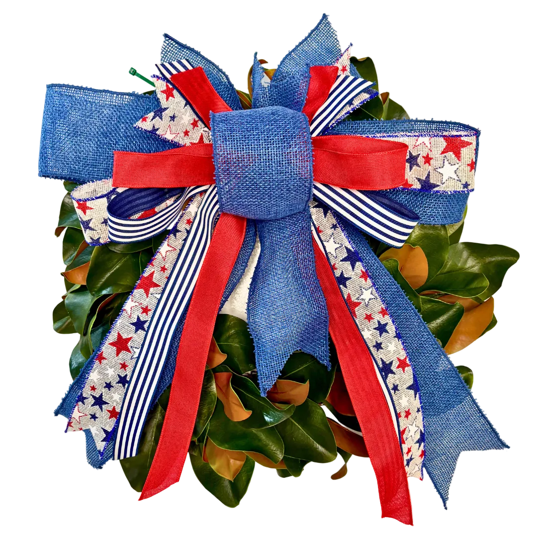 Decorative wreath with a large blue and red bow on a white background