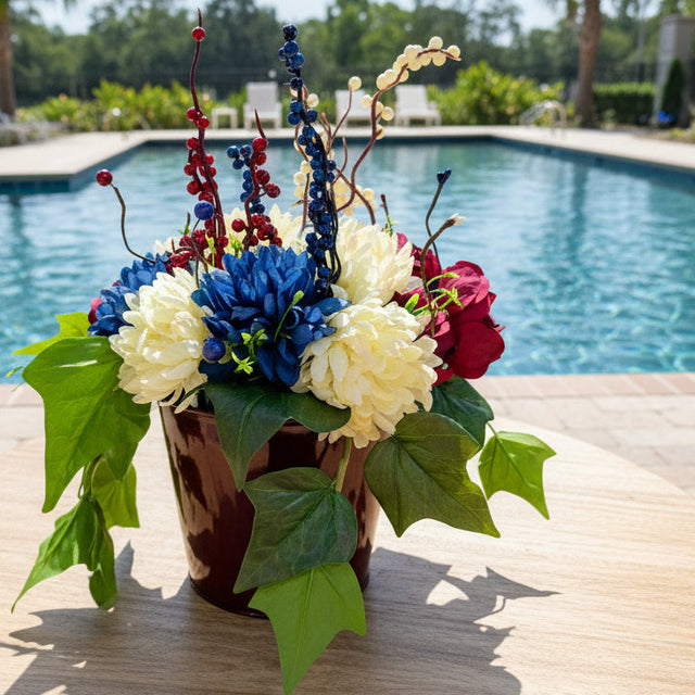Colorful floral arrangement on a table by a poolside
