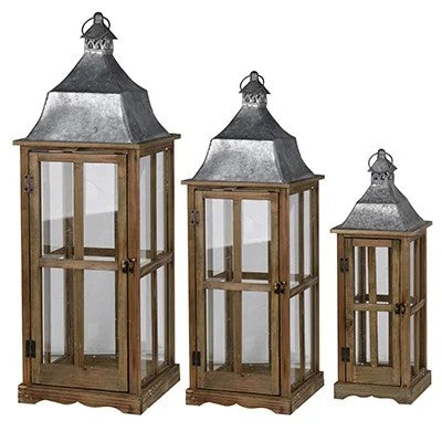 Set of three wooden lanterns with glass panels on a white background