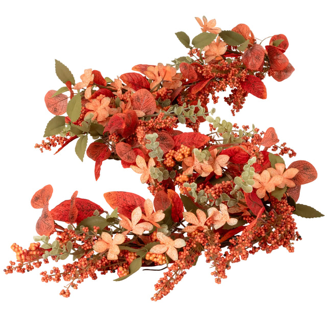 Decorative floral garland with red, orange, and green leaves on a white background
