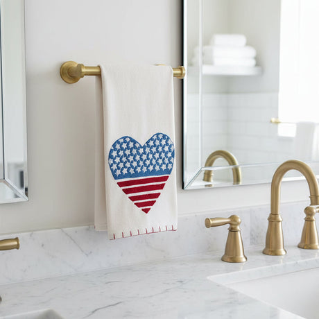 Towel with American flag heart design hanging on a towel rack.