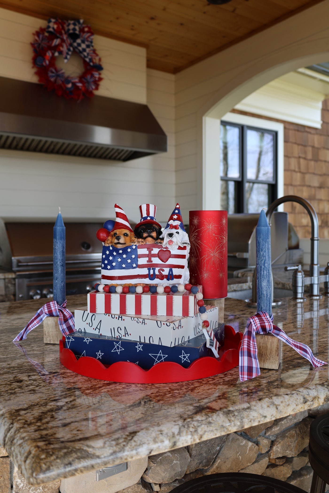 Decorative American flag-themed wreath on a fireplace mantle.