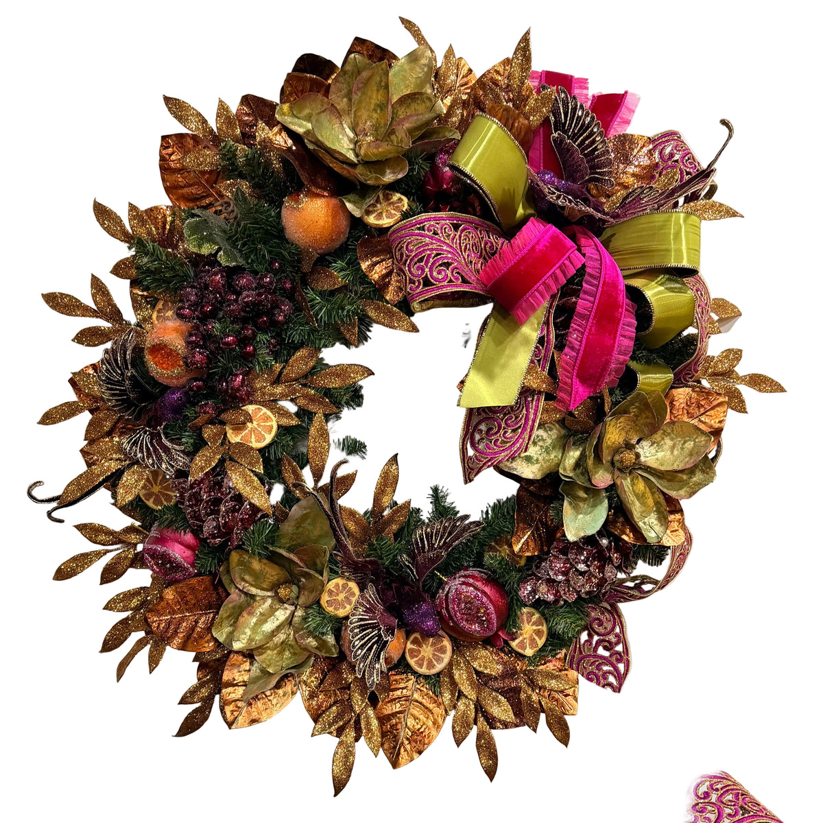 An autumn-themed artificial wreath decorated with metallic gold and bronze leaves, green pine branches, dried orange slices, purple berries, and a large pink and lime green ribbon bow, shown against a plain off-white wall. Christmas wreath in a non-traditional color scheme. Falliday
