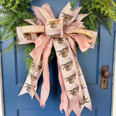 Decorative bow with bird pattern on a blue door
