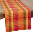 Plaid table runner with autumn colors on a wooden surface