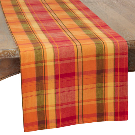 Plaid table runner with autumn colors on a wooden surface