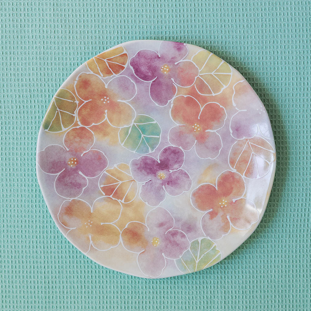 Round plate with floral design on a light blue background