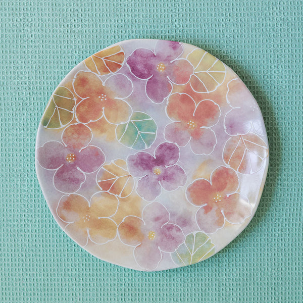 Round plate with floral design on a light blue background