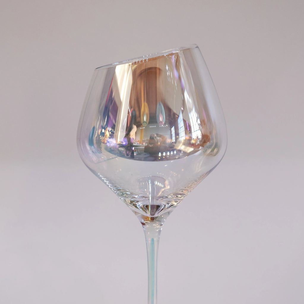 Clear irredescent wine glass on a white background