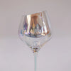 Clear irredescent wine glass on a white background