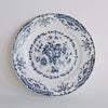 Decorative plate with blue floral pattern on a white background
