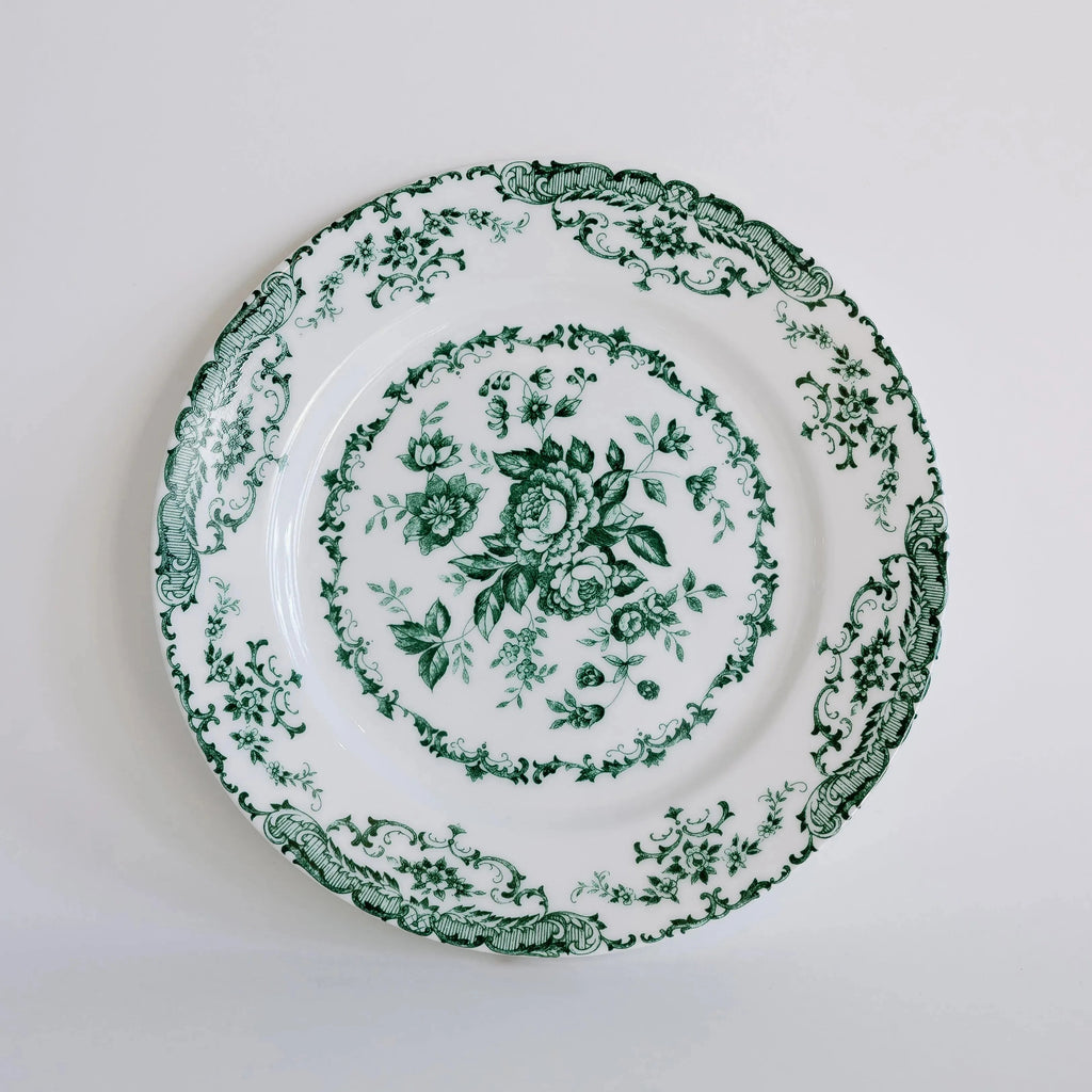 Decorative plate with green floral pattern on a white background