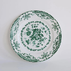 Decorative plate with green floral pattern on a white background