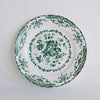 Decorative plate with green floral pattern on a white background