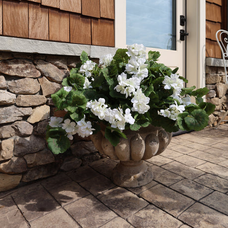outdoor planter filled with artificial realistic geraniums