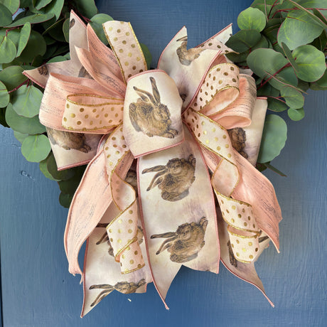 Decorative wreath with a large bow on a blue door