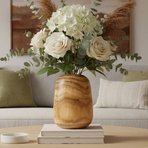 Living room with a beige sofa, wooden coffee table, and decorative elements.