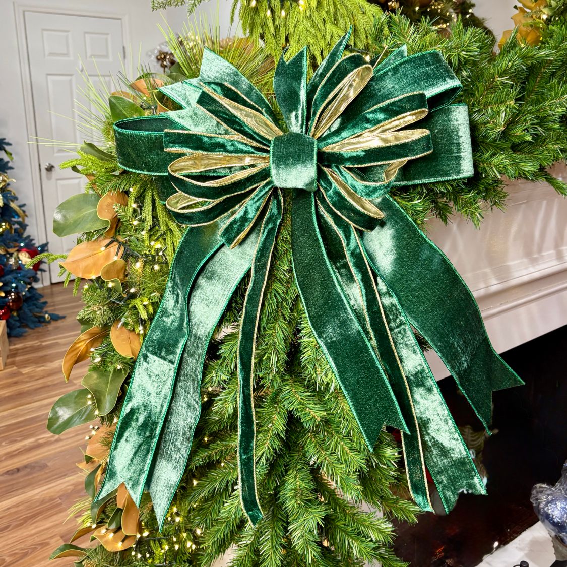 20 inch Emerald Velvet Classic hand-tied Christmas designer bow with emerald green velvet and gold-edged ribbon, on a garland