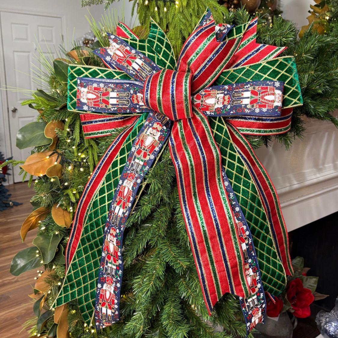 20 inch Navy Nutcracker hand-tied Christmas designer bow with navy nutcracker print, emerald diamond and red-green glitter stripe ribbon, on a garland