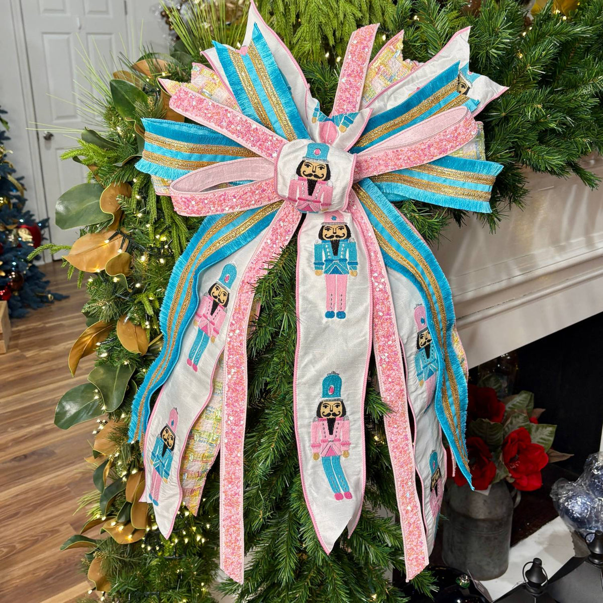 20 inch Enchanted Pink Nutcracker hand-tied Christmas designer bow with pink and blue nutcracker print, chenille check and sequin ribbon, on a garland