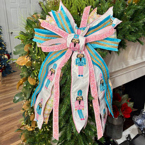 20 inch Enchanted Pink Nutcracker hand-tied Christmas designer bow with pink and blue nutcracker print, chenille check and sequin ribbon, on a garland