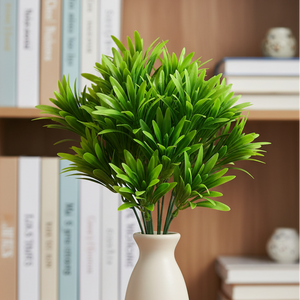 Artificial green plant branch on a white background