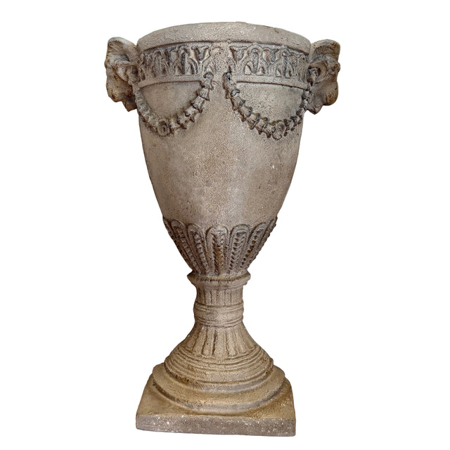 Decorative stone urn against a plain wall
