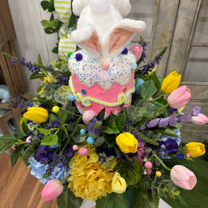 Bouquet with a decorative Easter bunny figure surrounded by flowers.