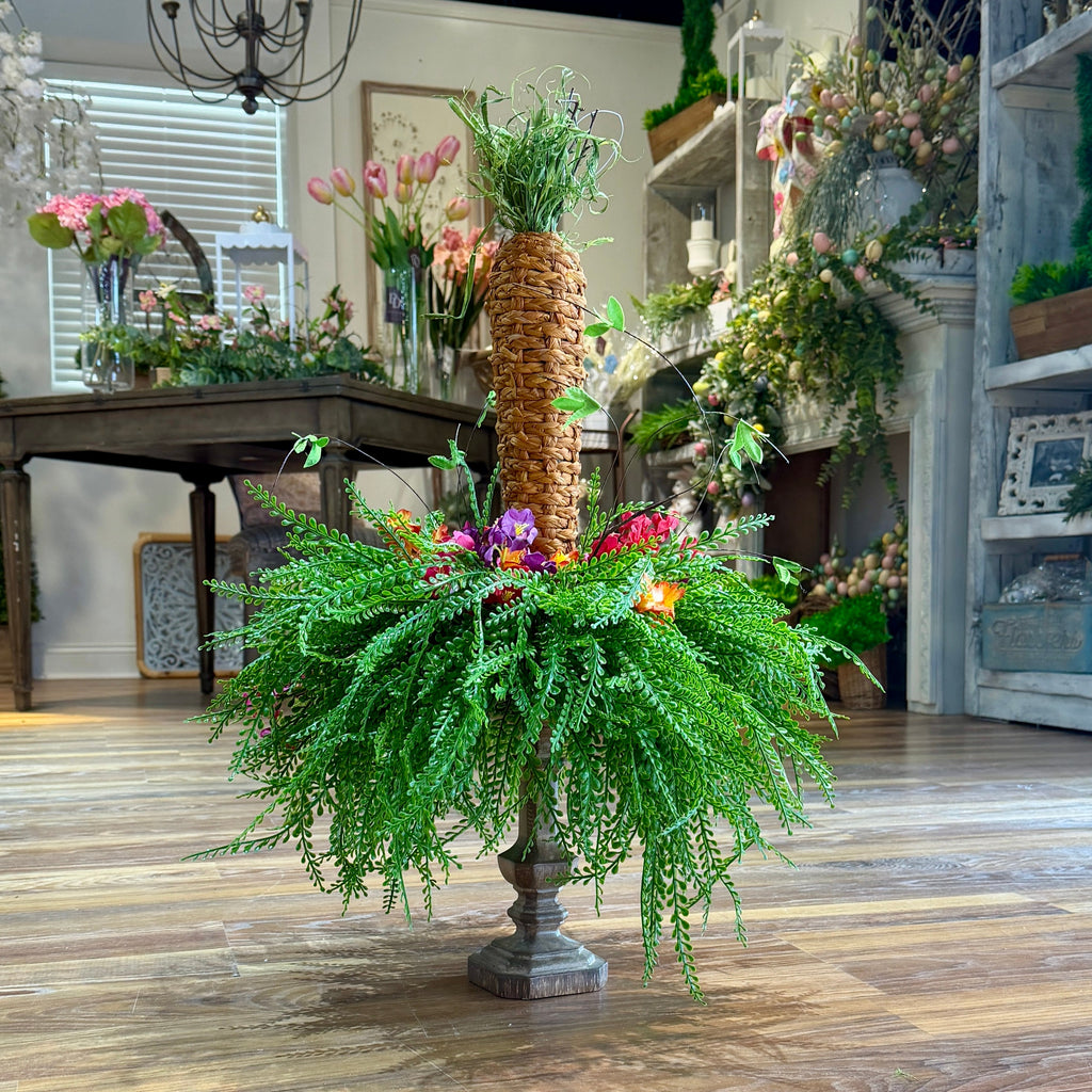 Decorative plant arrangement in a store setting with various floral displays.
