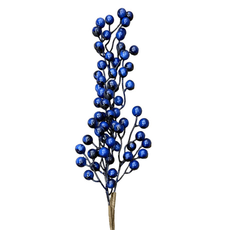 Artificial blue berry branch with a tag on a wooden surface
