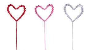 Three heart-shaped beaded picks on sticks, shown in red, pink, and silver, isolated on a white background.