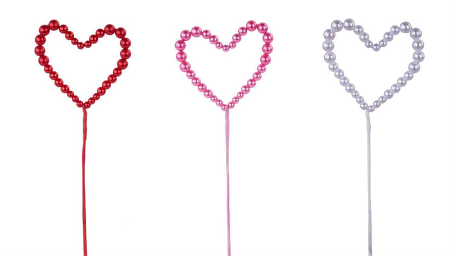 Three heart-shaped beaded picks on sticks, shown in red, pink, and silver, isolated on a white background.