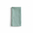 Folded light blue waffle-textured towel on a white background