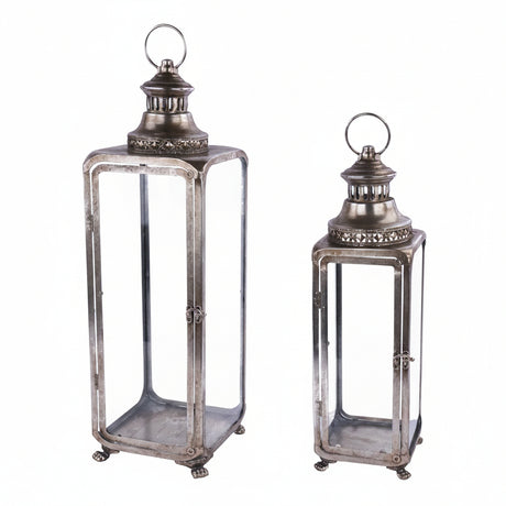 Two vintage-style metal lanterns with clear glass panels and top loop handles, shown on a plain white background.
