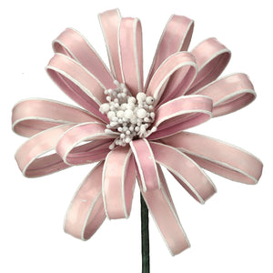 Decorative flower made of pink ribbons on a white background