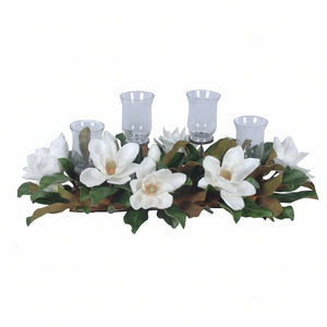Decorative candle holder with white flowers and green leaves on a white background
