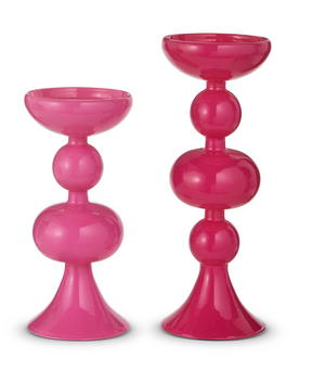 Two pink candle holders on a white background