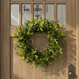 Green leafy ruscus wreath on a white background