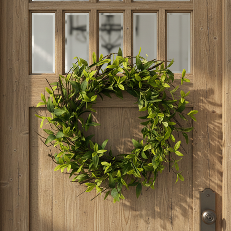 Green leafy ruscus wreath on a white background