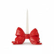 A glossy red bow-shaped candle holder for christmas valentines day and patriotic holidays