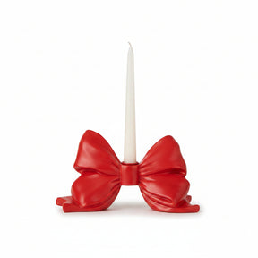 A glossy red bow-shaped candle holder for christmas valentines day and patriotic holidays