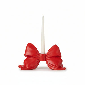 A glossy red bow-shaped candle holder for christmas valentines day and patriotic holidays