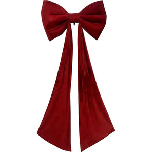 A huge deep red velvet bow with long, flowing tails, displayed against a plain white background. 