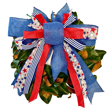 Decorative wreath with a large blue and red bow on a white background