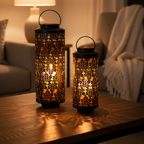 Two illuminated lanterns on a wooden surface with a cozy indoor setting.