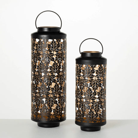 Two black lanterns with floral patterns on a white background