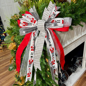 20 inch Silver Nutcracker hand-tied Christmas designer bow with nutcracker soldiers, red and silver ribbon, on a garland
